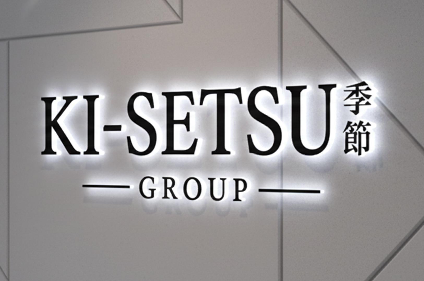 Backlit 3D logo signage for Ki-Setsu Group featuring the name in English and Japanese kanji characters on a modern textured wall.